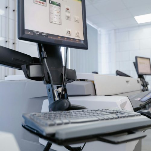 Close-up of a computer setup in a laboratory environment with technical equipment.
